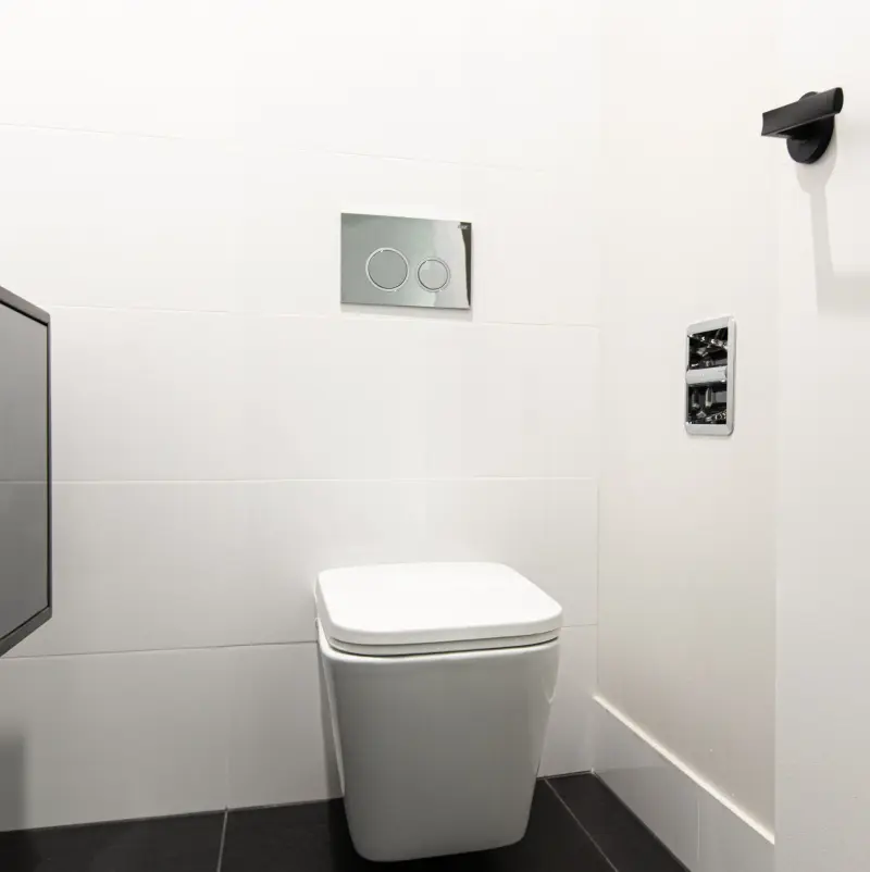 SmartRoll Chrome installed in white tile bathroom
