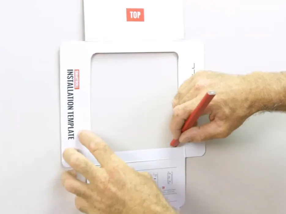 Place the SmartRoll installation template on the wall and mark the cut lines with a pencil
